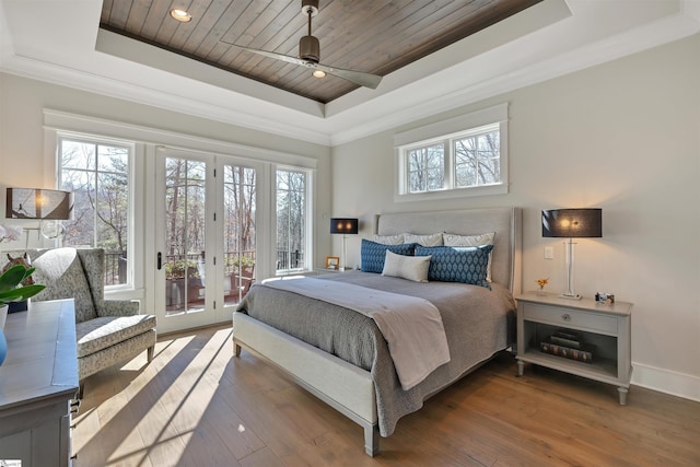 bedroom featuring access to outside, hardwood / wood-style floors, a raised ceiling, and wood ceiling