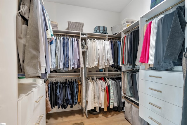 walk in closet featuring visible vents and wood finished floors