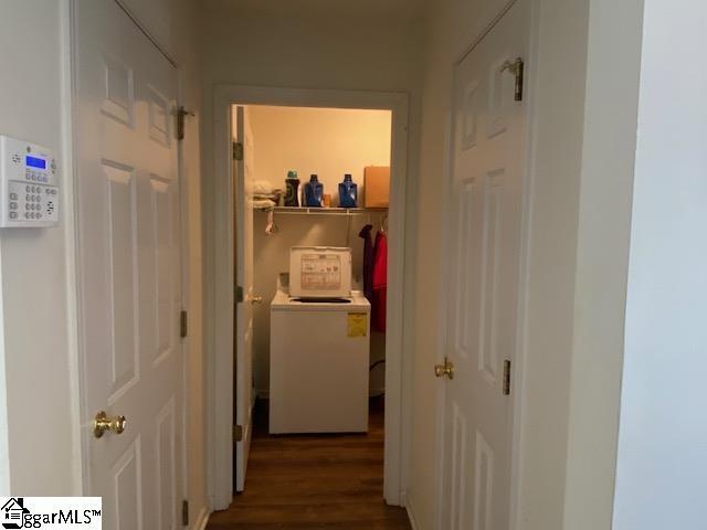 hallway featuring washer and clothes dryer and wood finished floors