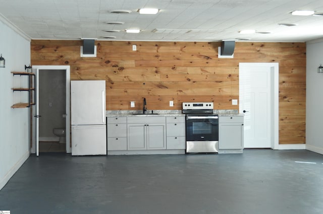 612 W Main St, Easley, SC 29640 - interior space featuring freestanding refrigerator, a sink, wooden walls, and baseboards