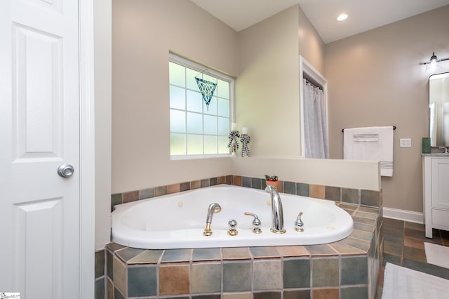 bathroom featuring recessed lighting, vanity, and a bath