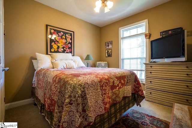 carpeted bedroom with baseboards and a ceiling fan