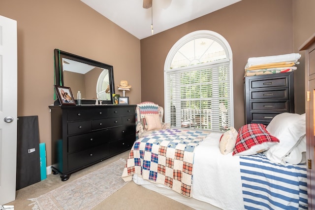 bedroom with a ceiling fan and light carpet