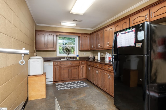 kitchen featuring dark countertops, finished concrete floors, freestanding refrigerator, a sink, and dishwasher