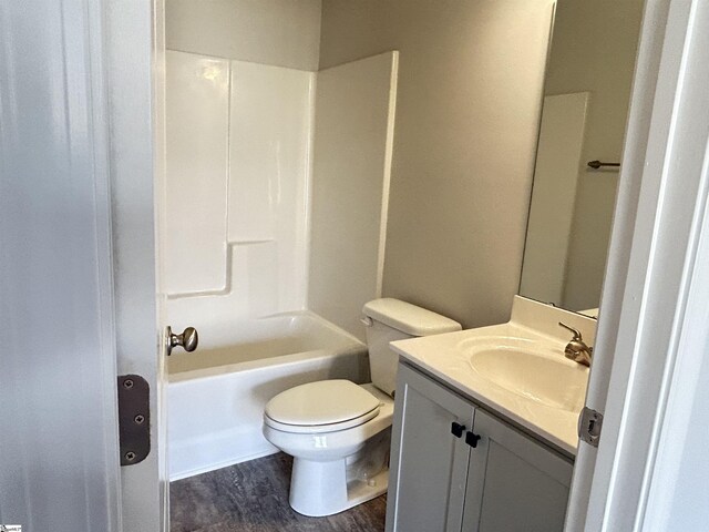 bathroom featuring shower / bathing tub combination, vanity, toilet, and wood finished floors