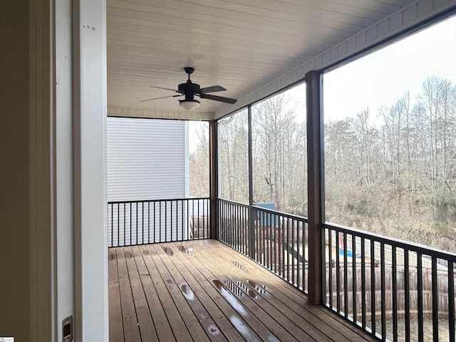 unfurnished sunroom with a ceiling fan