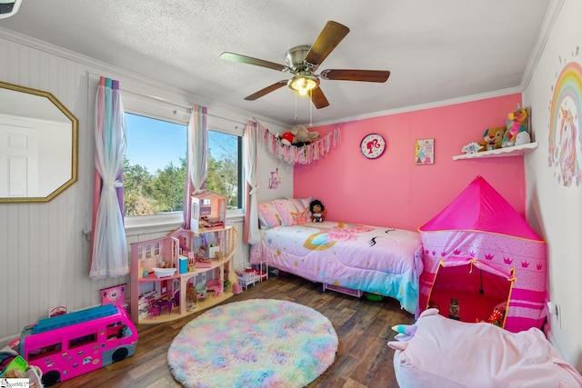 bedroom featuring ornamental molding, a textured ceiling, and wood finished floors