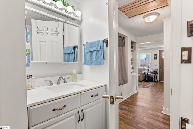 bathroom with vanity and wood finished floors