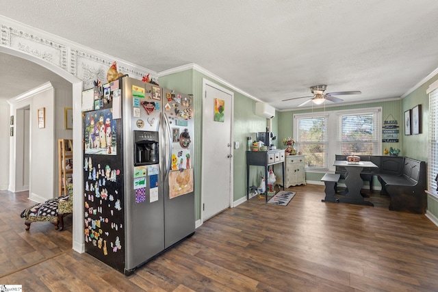 kitchen with crown molding, arched walkways, stainless steel refrigerator with ice dispenser, and wood finished floors