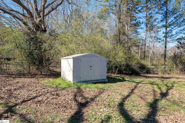 view of shed with a forest view