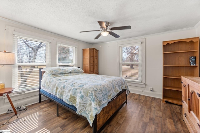 bedroom with a textured ceiling, ceiling fan, ornamental molding, and dark wood-style flooring