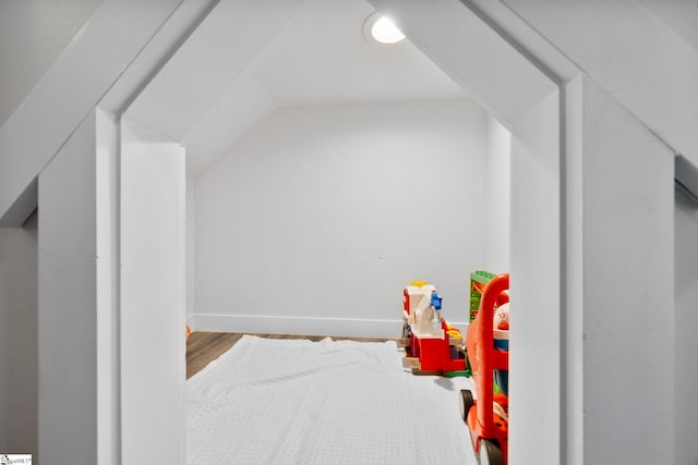 recreation room with lofted ceiling, wood finished floors, and baseboards