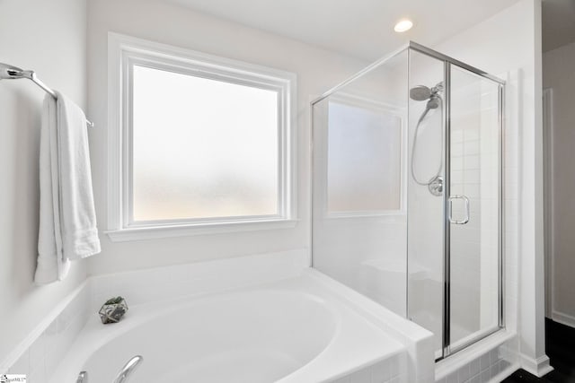 full bathroom featuring a stall shower, a bath, and recessed lighting