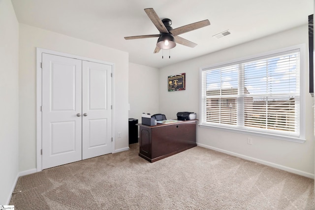 carpeted office featuring visible vents, ceiling fan, and baseboards