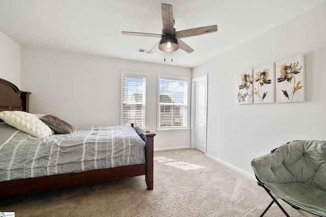 carpeted bedroom with ceiling fan, visible vents, and baseboards