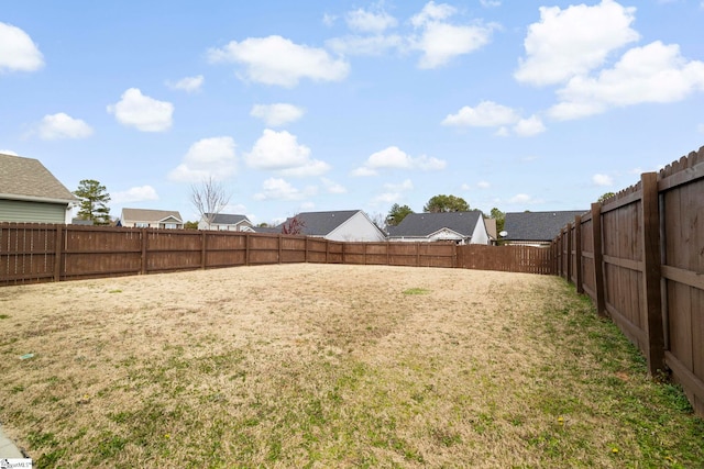 view of yard with a fenced backyard