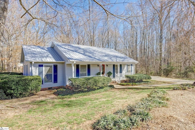 ranch-style home featuring a porch, a front yard, crawl space, and metal roof