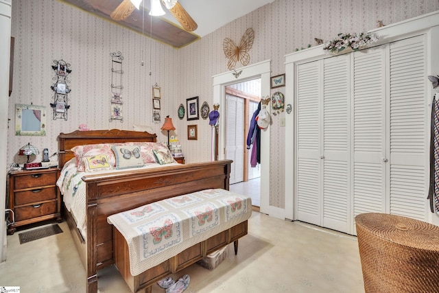 bedroom with concrete floors, a closet, a ceiling fan, and wallpapered walls