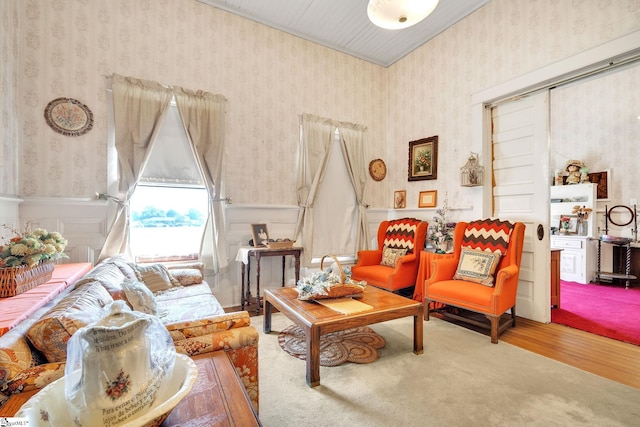 living room with wainscoting, wood finished floors, and wallpapered walls