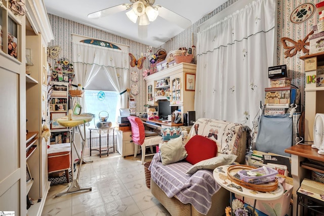 interior space with a ceiling fan and wallpapered walls