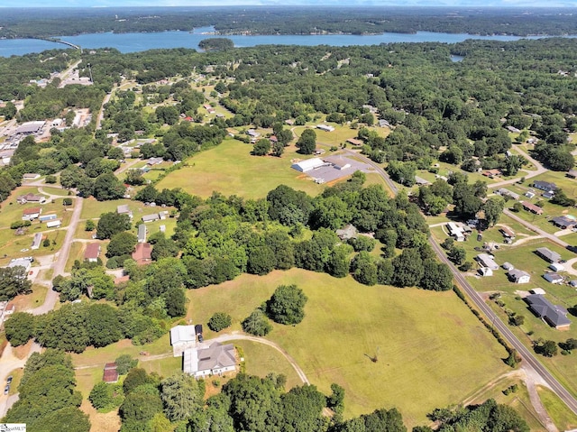 drone / aerial view featuring a water view and a view of trees