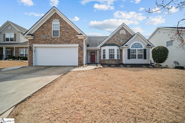 view of front facade featuring a garage, concrete driveway, and stone siding