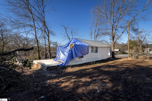 view of side of property featuring metal roof