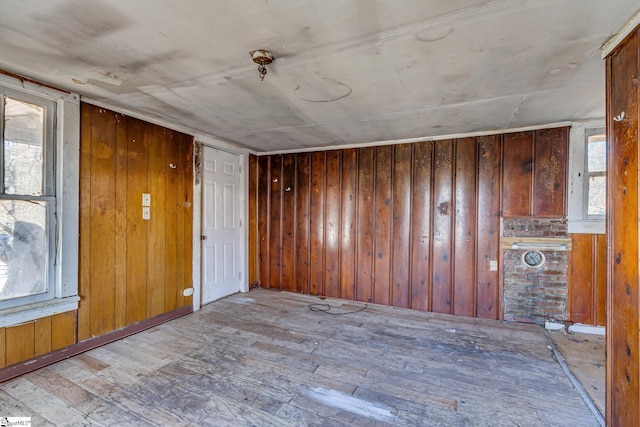 spare room with wood finished floors and wooden walls