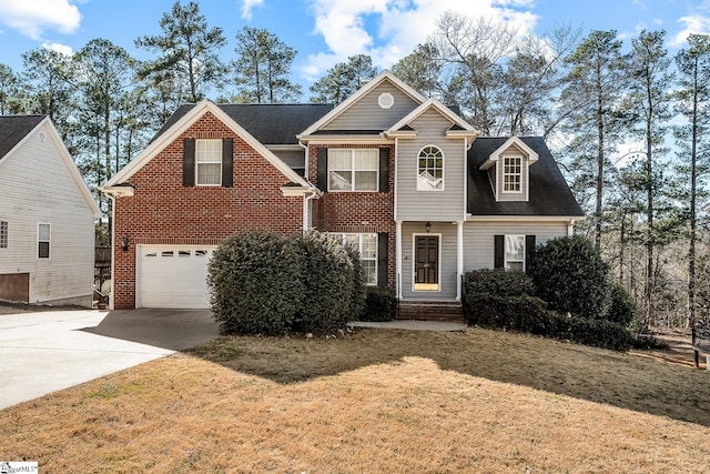 view of front of property with a garage, driveway, brick siding, and a front yard