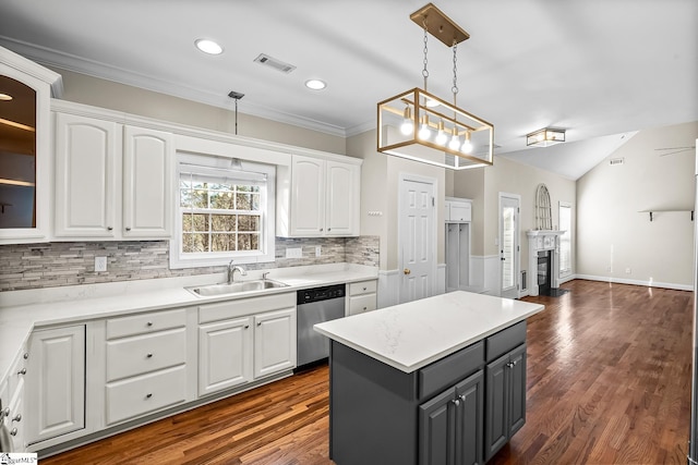 kitchen with a fireplace, gray cabinets, white cabinets, a sink, and dishwasher