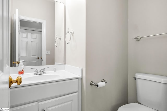 bathroom with toilet and vanity