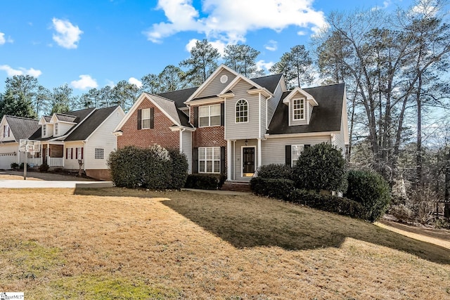 view of front of property with a front lawn and brick siding