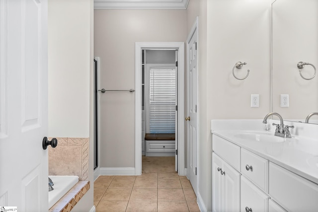 full bath featuring tiled tub, vanity, and tile patterned floors