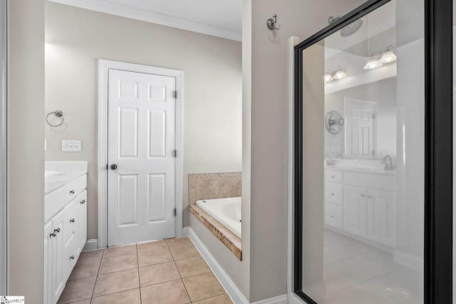 bathroom featuring a garden tub, tile patterned flooring, and vanity