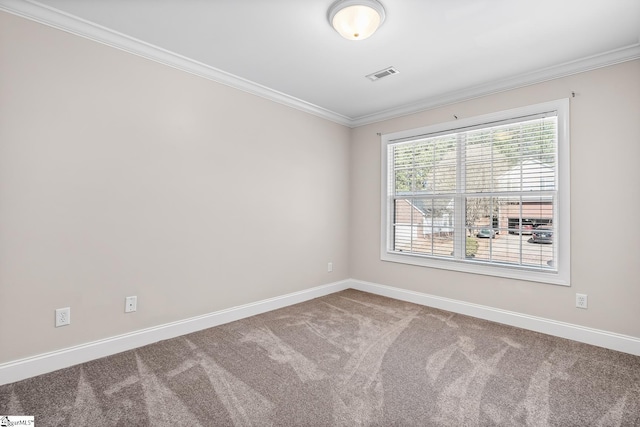 carpeted empty room with visible vents, crown molding, and baseboards