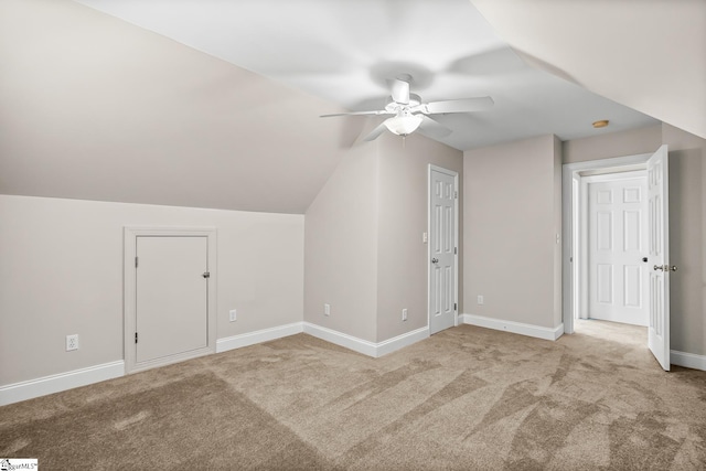 bonus room featuring carpet floors, vaulted ceiling, baseboards, and a ceiling fan