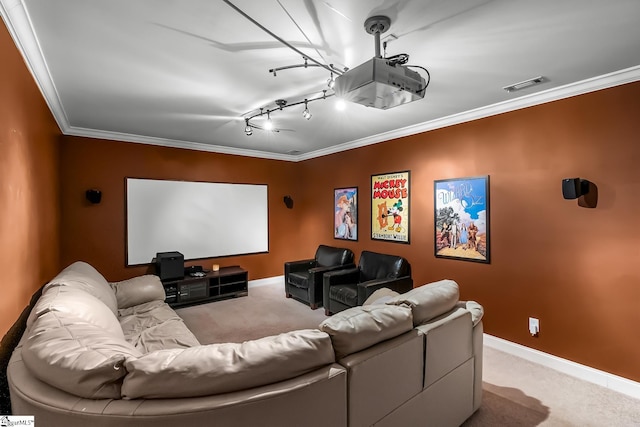 home theater room featuring light carpet, ornamental molding, visible vents, and baseboards