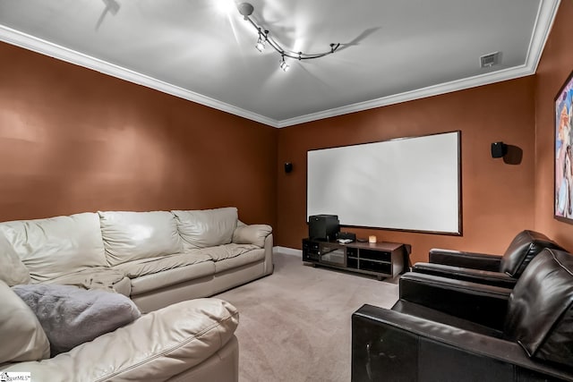 cinema room featuring carpet floors, track lighting, visible vents, and crown molding