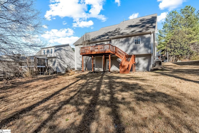 rear view of property with stairs, a yard, and a deck