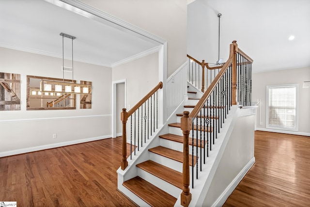 stairs featuring ornamental molding, recessed lighting, baseboards, and wood finished floors