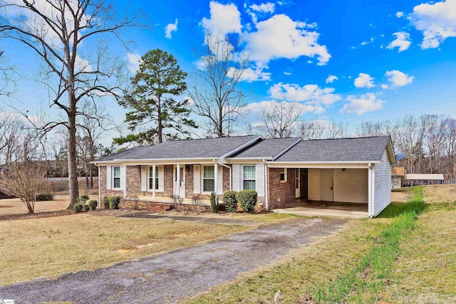 ranch-style home featuring driveway, roof with shingles, a front lawn, a porch, and brick siding