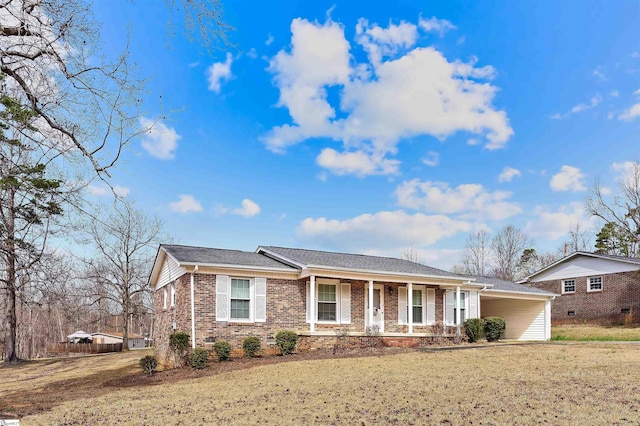 ranch-style home with a front yard, a porch, and brick siding