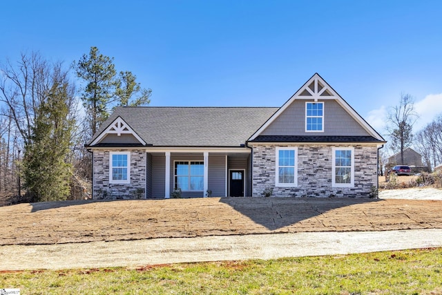 craftsman inspired home featuring stone siding and roof with shingles