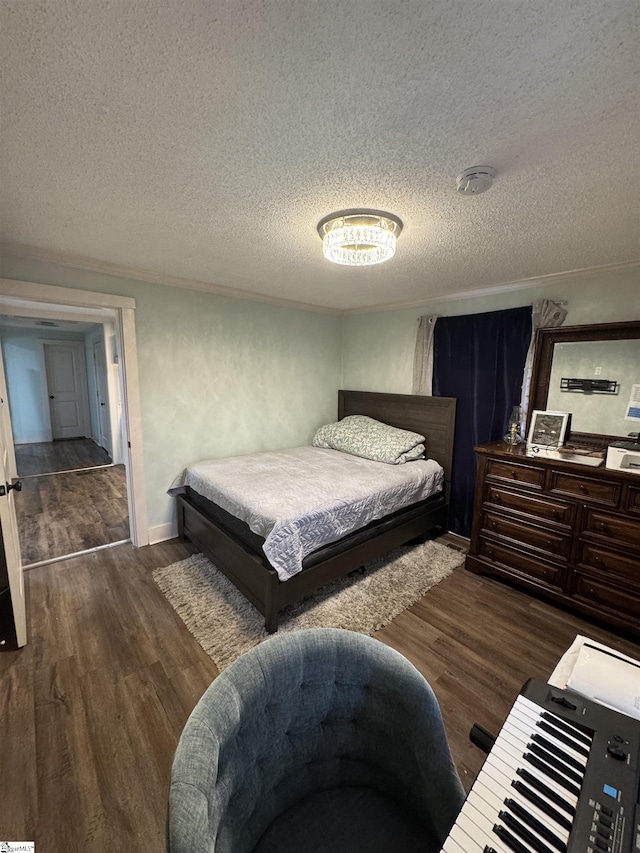 bedroom featuring a textured ceiling and wood finished floors