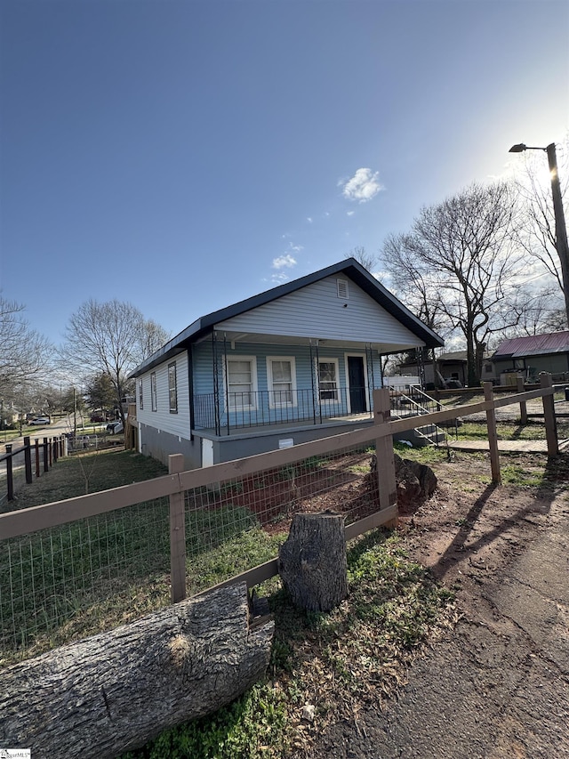 view of front of house featuring fence