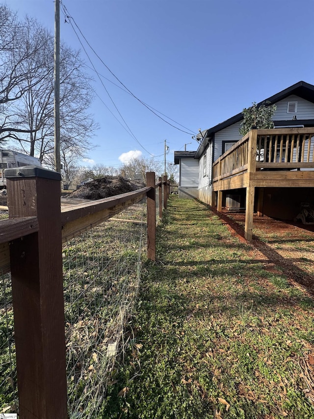 view of yard with a deck and fence