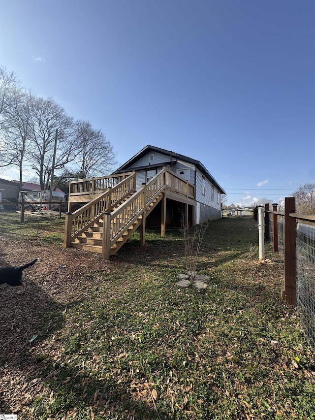 back of house with fence, a wooden deck, and stairs