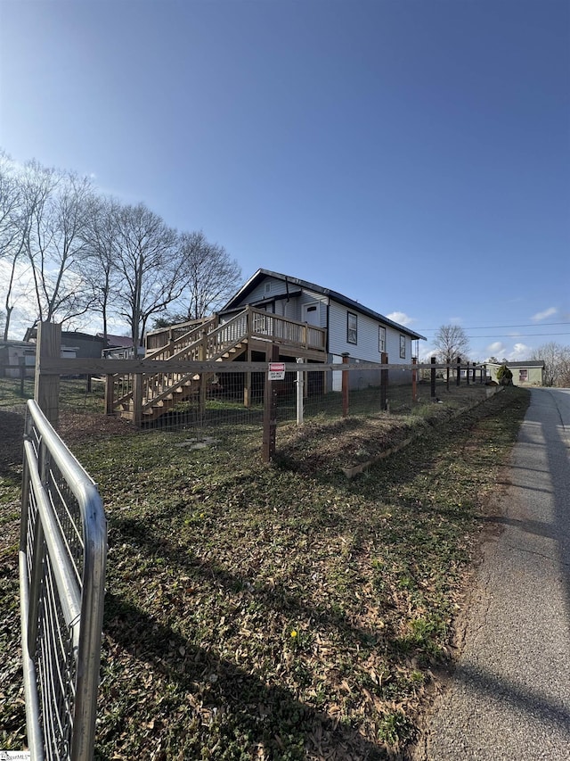 exterior space with fence and a wooden deck