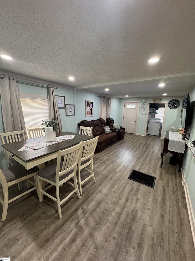 dining space with a textured ceiling, wood finished floors, and recessed lighting