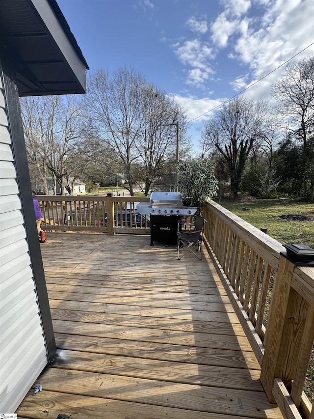 wooden deck featuring a grill